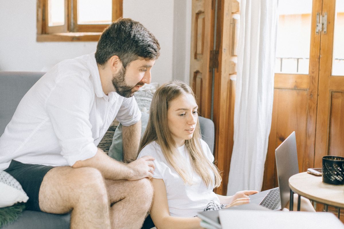 A pair reviewing records on screen
